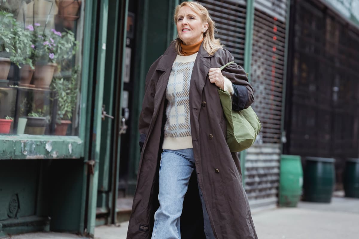 A woman in her forties walking along a town street