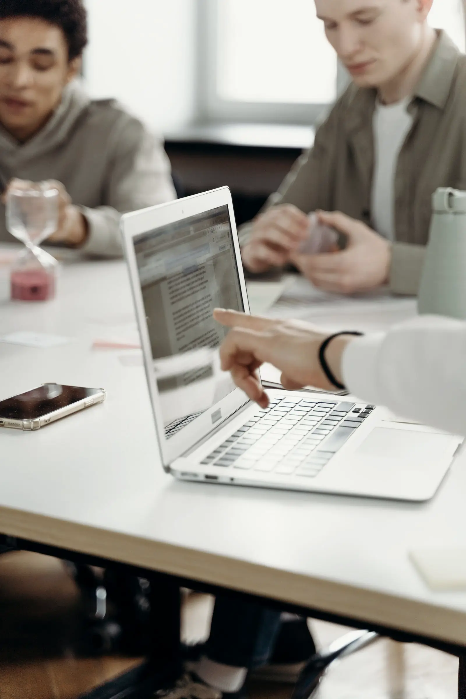 Colleagues working on laptops around a table