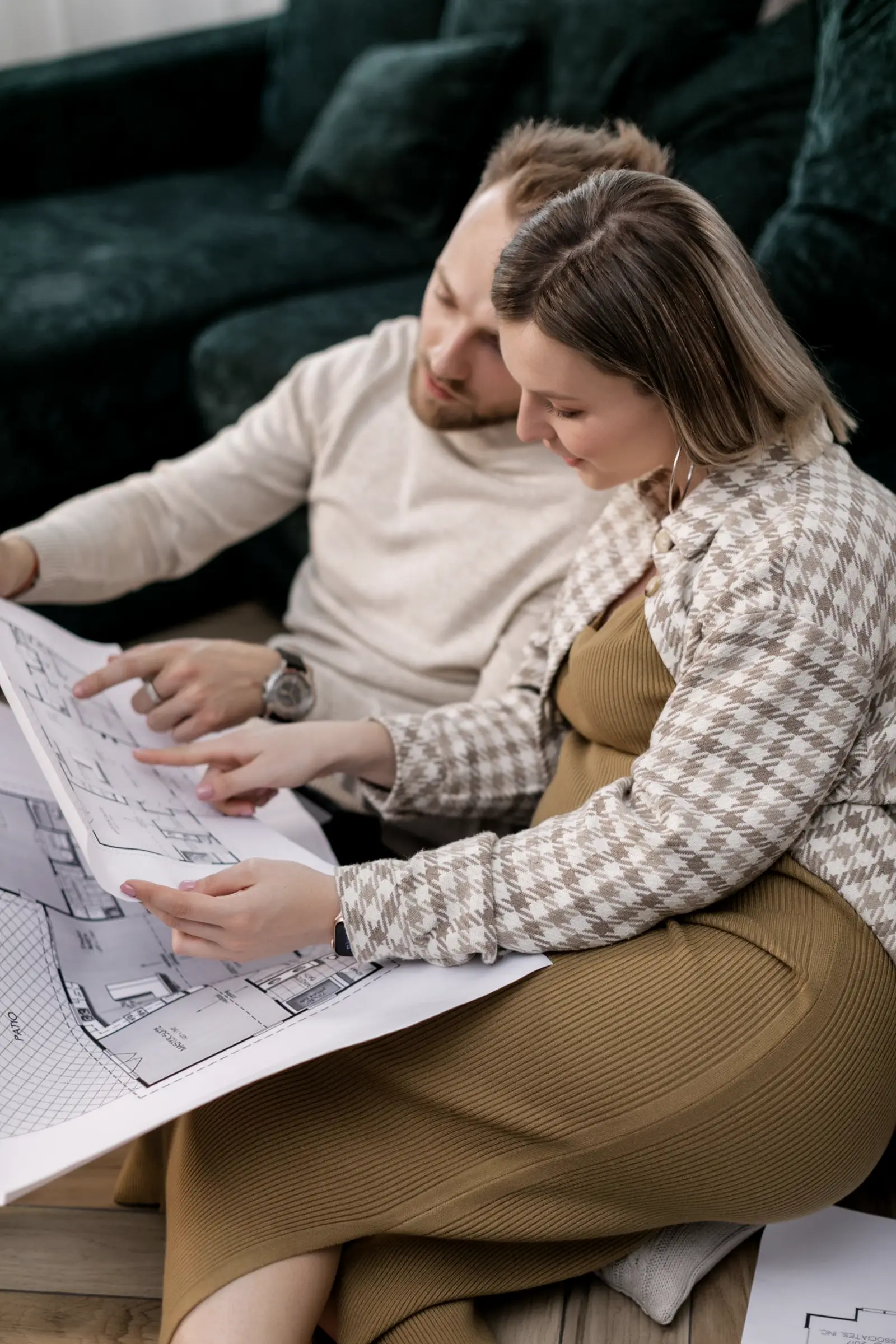 A couple looking at plans together on a sofa
